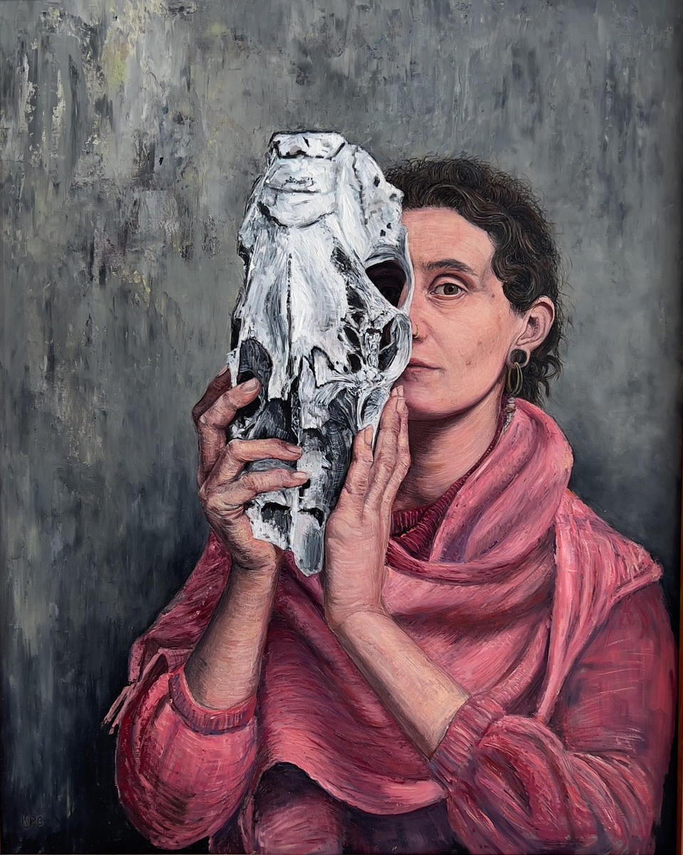 Oil painting of a woman in a pink shawl holding a white horse skull up to her face, obscuring half of it, against a muted gray-green background.