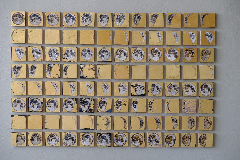 Close-up detail of Cyclum Lunarem showing the painted moon phases on gold leaf squares arranged in horizontal rows, revealing the textured brushwork and waxing and waning lunar cycle