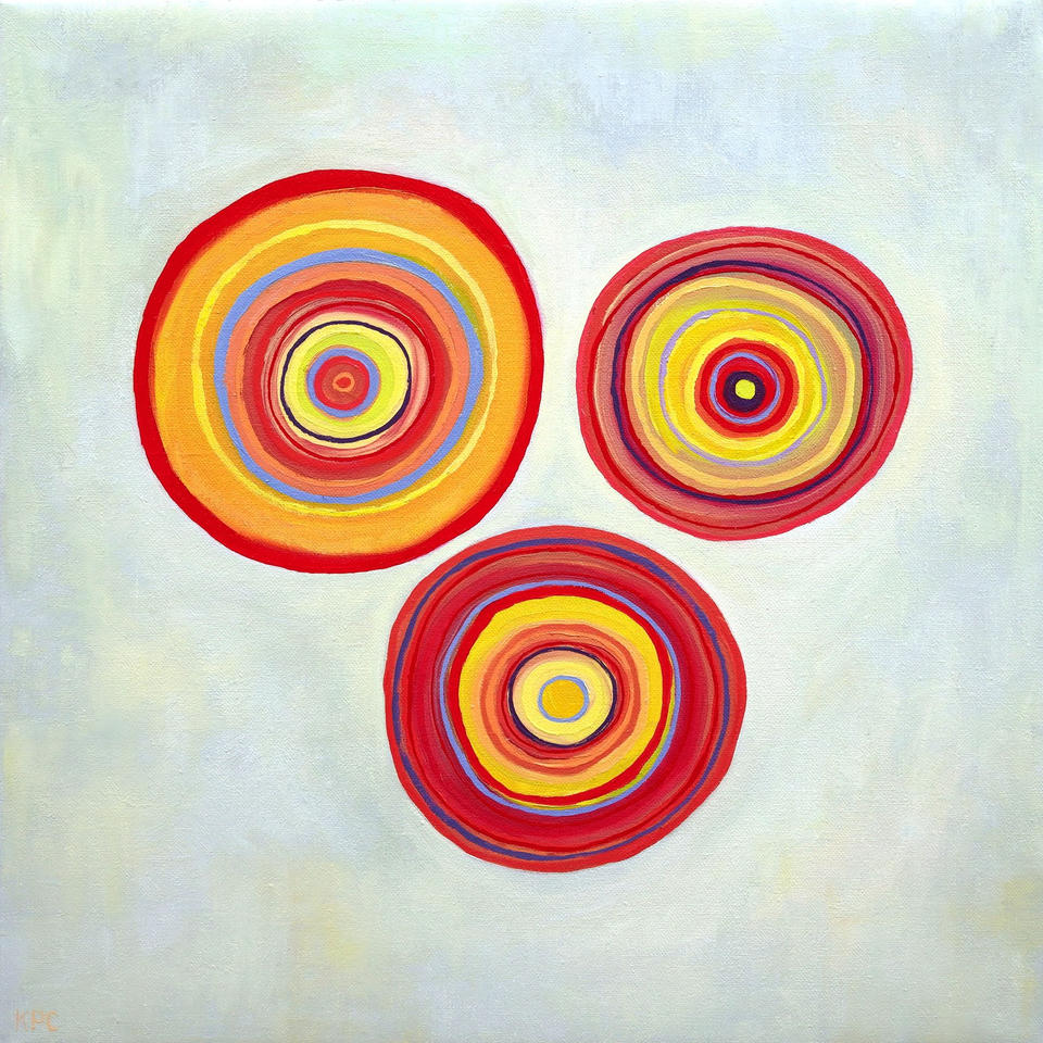 Oil painting of three concentric circle forms floating on a pale gray-green background, each composed of layered rings in warm reds, oranges, yellows, and touches of blue and purple, evoking orbital or cellular structures.
