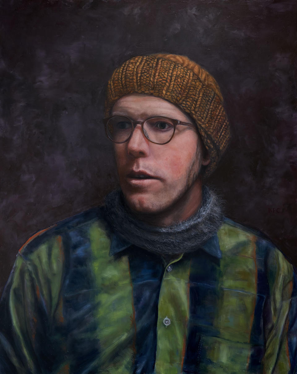 A self portrait by Kyle Parker Cunningham gazing left wearing a yellow knit hat, scarf and green shirt.